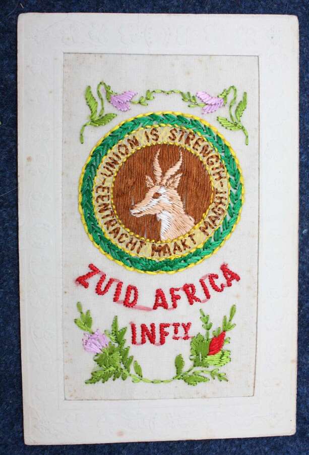 WW1 Silk Embroidered postcard of The South African Infantry Springbok Cap Badge.