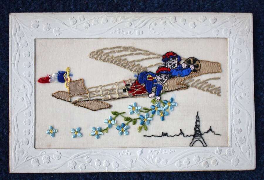 WW1 Silk Embroidered Postcard. Two French soldiers flying and dropping forget me nots.
